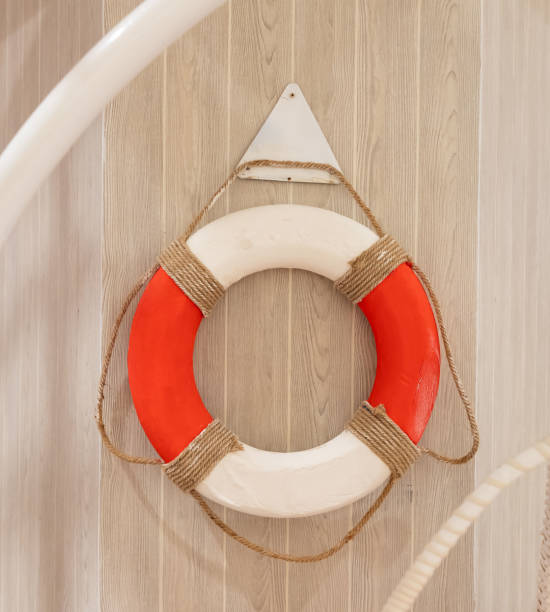 istock A red and white life preserver on wall. 2203563286