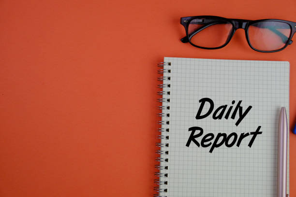 istock Daily Report text on a notebook. A summary that provides information about tasks, activities, progress, or events that happened 2203564133