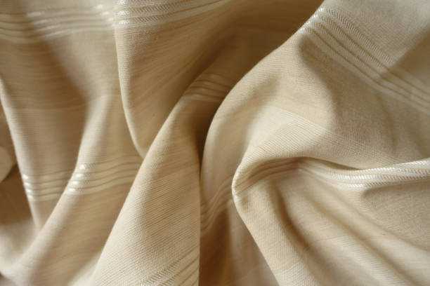 istock Crumpled light beige striped cotton and polyester fabric 2203565984