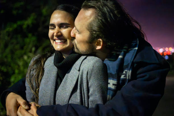 istock Cheerful young couple enjoying night in park 2203566843