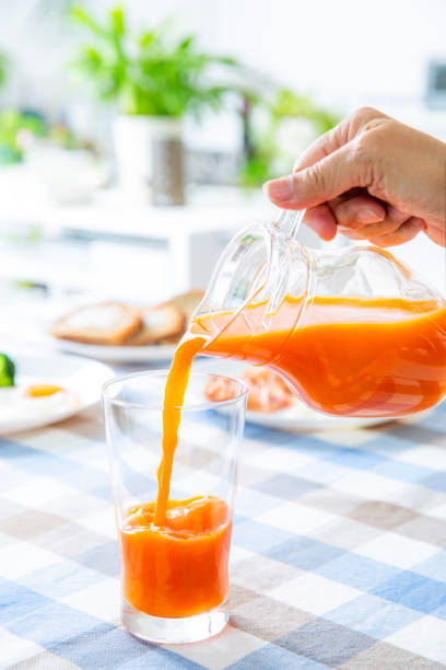 Pour vegetable juice. Healthy cooking, refreshing breakfast table,