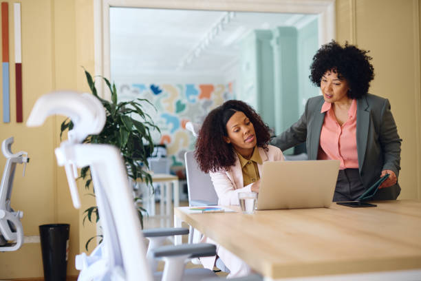 istock Two Businesswomen Collaborating on a Laptop in a Modern Office 2203569974