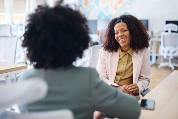 istock Two businesswomen discussing during a meeting in a modern office 2203570019
