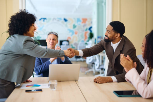 istock Business people shaking hands during a meeting in a modern office 2203570091