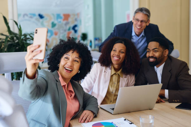 istock Business team taking a selfie in the office during a meeting 2203570220