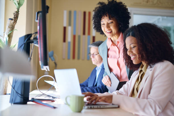 istock Businesswomen collaborating on a project in a modern office 2203570358