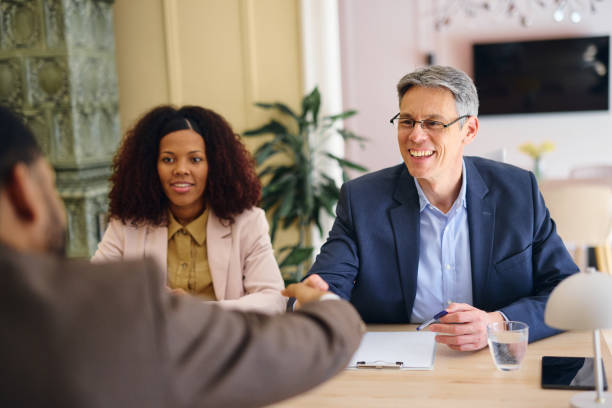 istock Business partners shaking hands at modern office during a meeting 2203570502