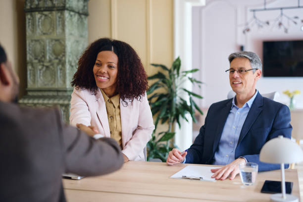 istock Smiling businesswoman shaking hands with a candidate during a job interview 2203570525