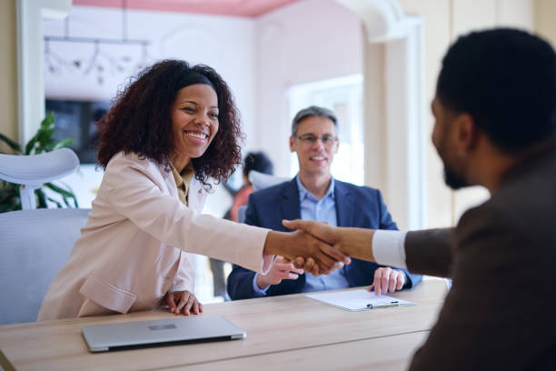 istock Businesspeople shaking hands during a meeting in a modern office 2203570536