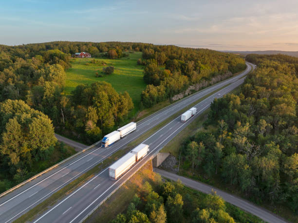 istock Trucks on the highway in a scandinavian summer landscape 2203570567