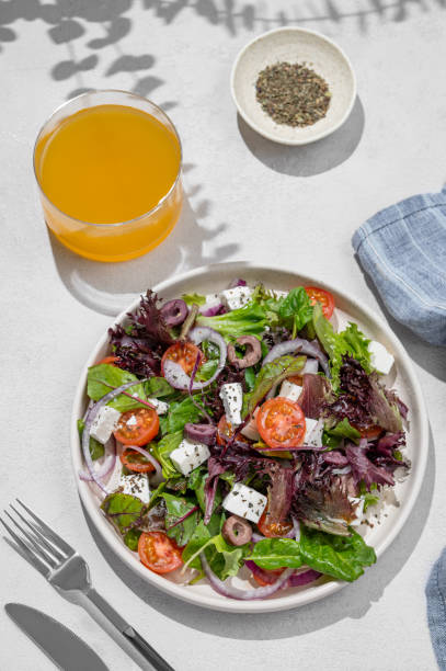 istock Vegetable salad (Greek salad) with  tomatoes, cheese, lettuce, olives and onion in a plate 2203571904