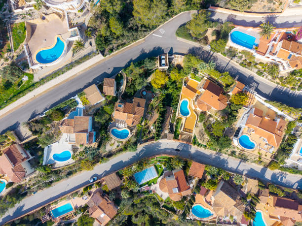 istock Aerial view of luxury villas with pools in a Mediterranean setting 2203572028