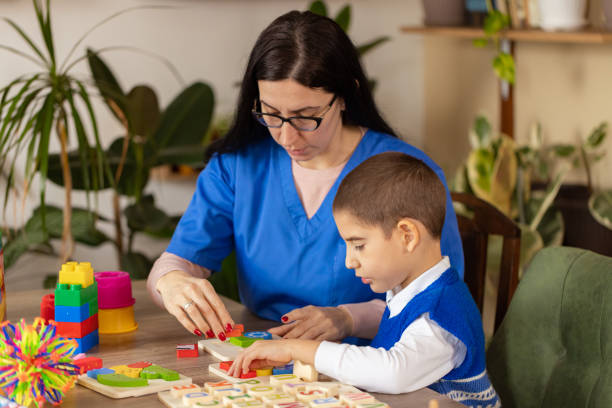 istock Nurse Helps Child with Autism 2203573393