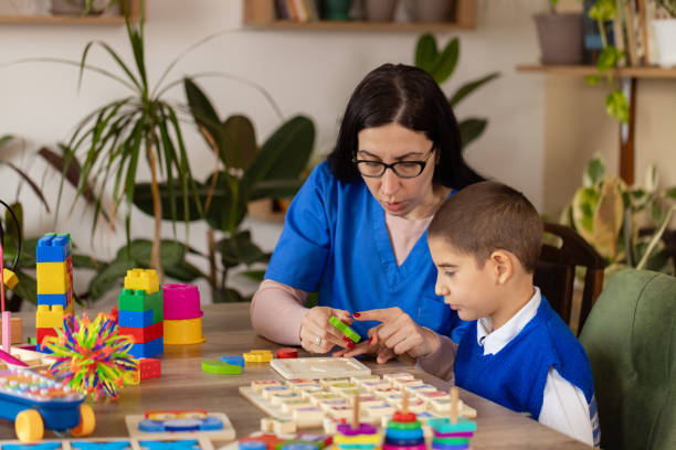 istock Nurse Helps Child with Autism 2203573395