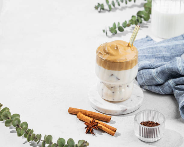 istock Dalgona coffee in a glass on a light background with spices and napkin. 2203574129