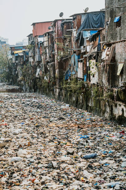 istock Urban Overcrowding and Pollution in Dense Slum Area Along River 2203577019