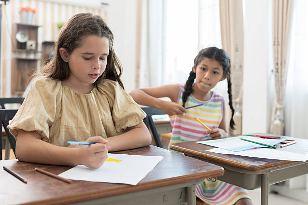 istock Group of children drawing and learning art in classroom at school 2203578711