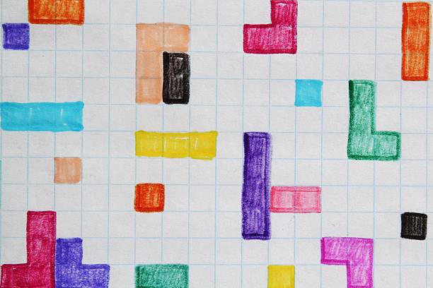 Colored felt-pen geometric shapes on graph paper. Handmade tetris figures. Abstract doodle shapes drawn on square grid paper. Sketch blocks on grid background. Hand-drawn block patterns on paper