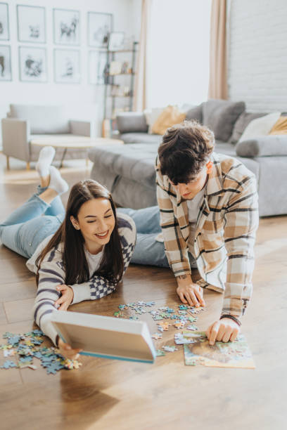 istock Couple solving a puzzle together at home 2203581534