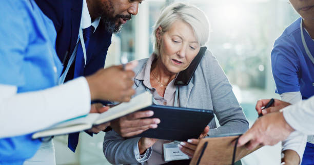 istock Woman, medical team or multitasking with tablet, phone call or document for overworked chaos or busy hospital. Female person, healthcare employees or demanding colleagues with technology or paperwork 2203581700
