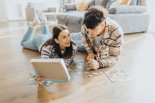 istock Couple solving a puzzle together at home 2203581713