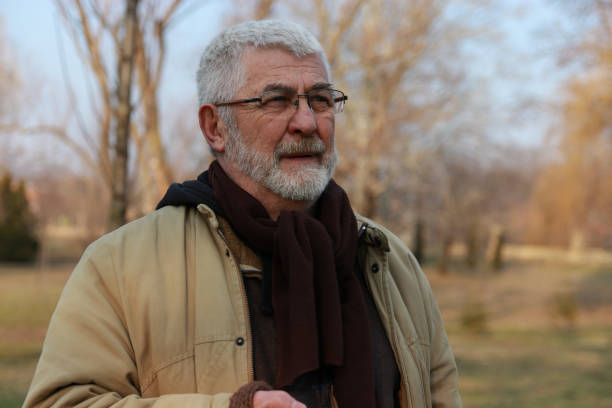 istock Senior man walking in public park 2203582201