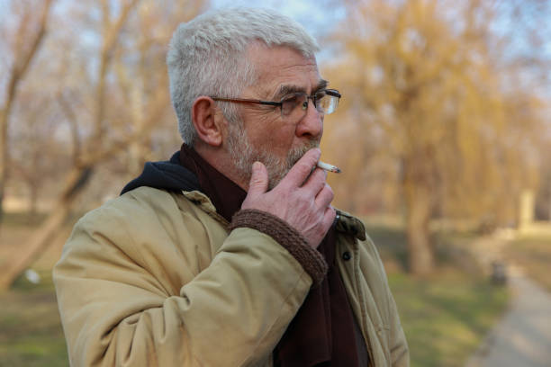 istock Senior man walking in public park 2203582247