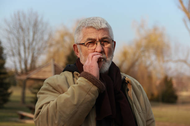 istock Senior man walking in public park 2203582285