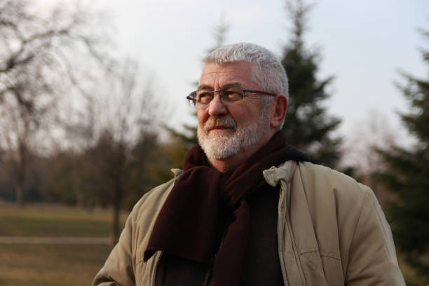 istock Senior man walking in public park 2203582342