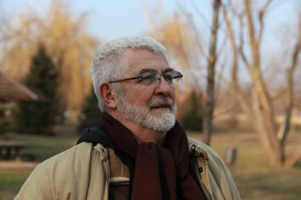 istock Senior man walking in public park 2203582348