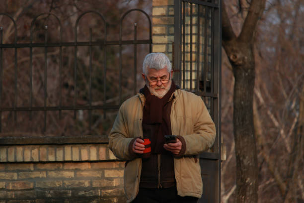 istock Senior man walking in public park 2203582486