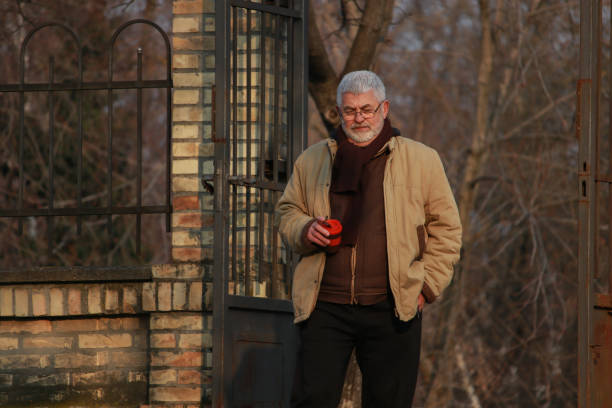 istock Senior man walking in public park 2203582487