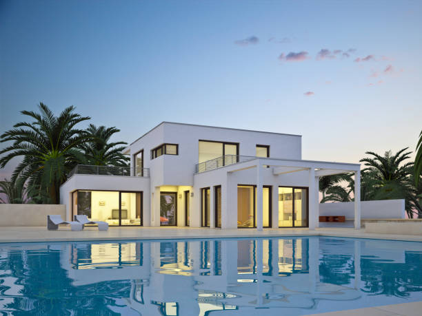 istock Modern cubic villa with palms and pool in the evening 2203586234