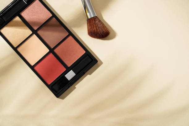 istock Make up products at colored background with hard shadows. 2203587255