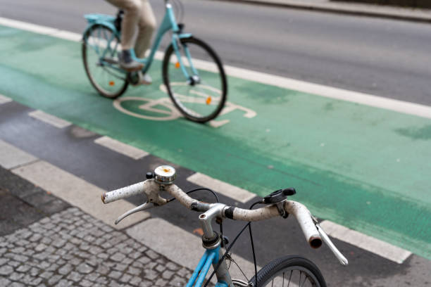 istock Bicycle handlebar in front of cyclist on a bicycle lane 2203587594