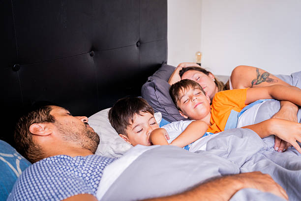 istock Family sleeping at home 2203587597