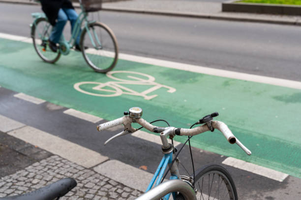 istock Bicycle handlebar in front of cyclist on a bicycle lane 2203587622