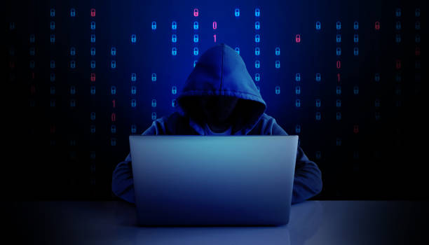 istock Cybersecurity Threat Concept with Hooded Hacker in Dark Background 2203587754