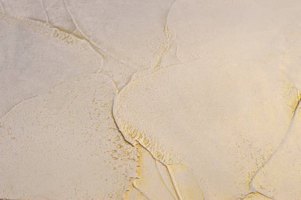 istock Decorative Venetian plaster with a texture molded with a spatula, plastic surface with gold, a play of light and shadow 2203589633