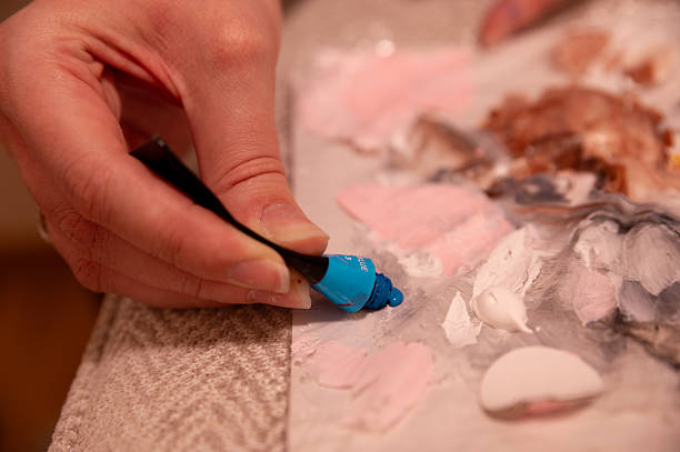 istock Artist squeezing blue paint onto a palette – creative painting process 2203590516