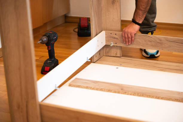 istock Man assembling wooden furniture – DIY home improvement project 2203593909
