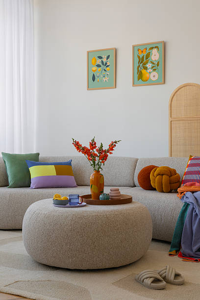 istock Sophisticated interior design featuring a comfortable beige sofa, colorful pillows, and a modern, minimalistic decor style 2203596270