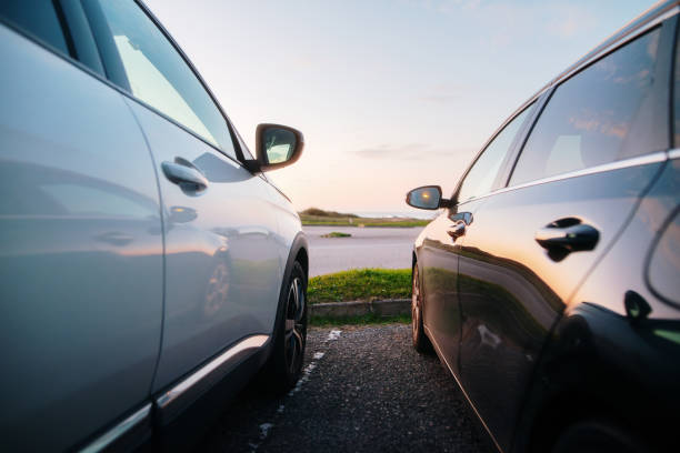 Two cars next to each other in an outdoors parking lot