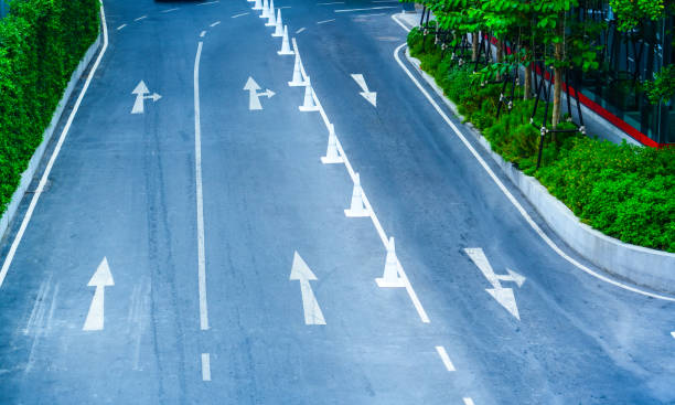 istock Road marking arrow forward and left on road surface, aerial view 2203598726