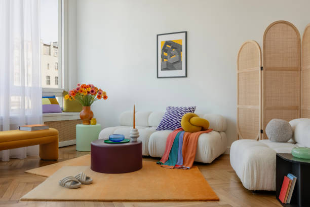 istock Modern sofa with textured cushions, a striking knot pillow, and bold artwork creating a unique living room vibe. Home decor. 2203599222