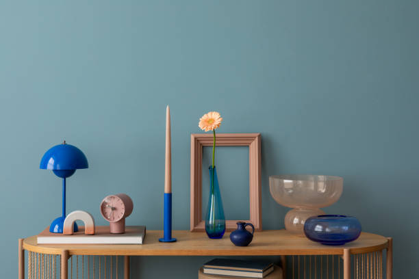 istock Elegant display with modern decor including a blue lamp, minimalist vases, and sculptural glassware, creating a serene and sophisticated tabletop arrangement. 2203602207