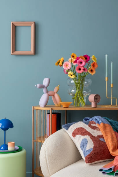 istock Bright and inviting living space featuring fresh flowers, colorful decor, and a cozy white sofa with a bold cushion, blending playful accents with a modern aesthetic. 2203602240