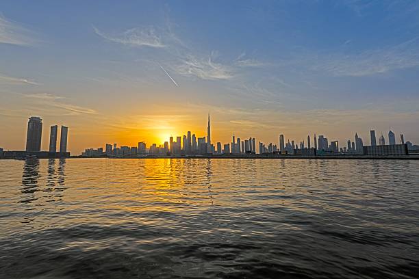 istock Panoramic view of Dubai skyline at sunset with Burj Khalifa and water reflections 2203602503