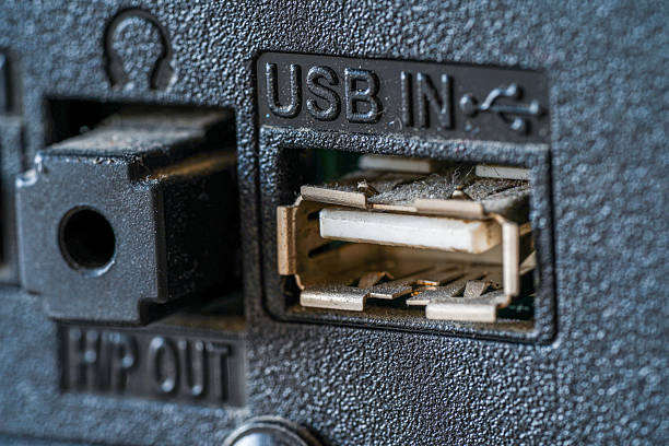 Close-up view of a dusty USB port, highlighting the metal connectors and intricate detail of the technology's input.