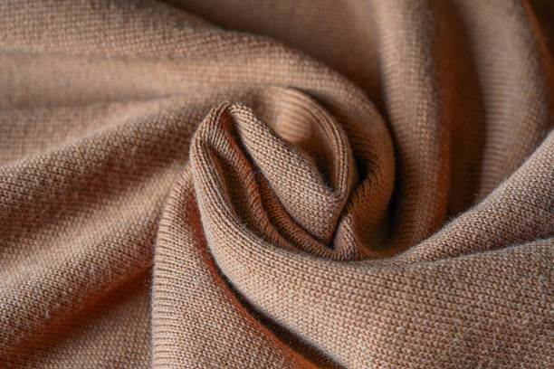 A close-up of soft, textured brown knitted fabric, perfect for showcasing cozy clothing, textiles, and home wear photography.